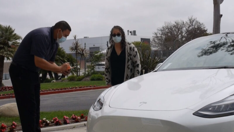 A Tony's Body Shop estimator walking a customer around their vehicle
