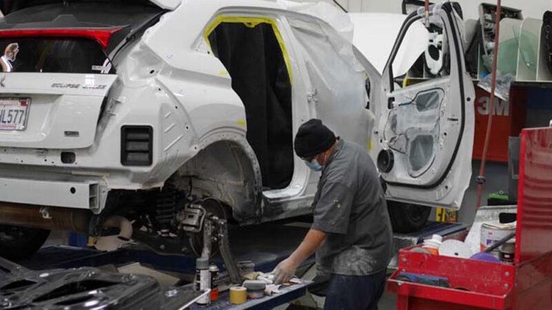A vehicle stripped down mid-repair at Tony's Body Shop while parts are on order
